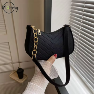Bolso de hombro Molfmy de media luna para mujer Bolso de hombro Molfmy de color negro con cadena dorada sostenido por una modelo